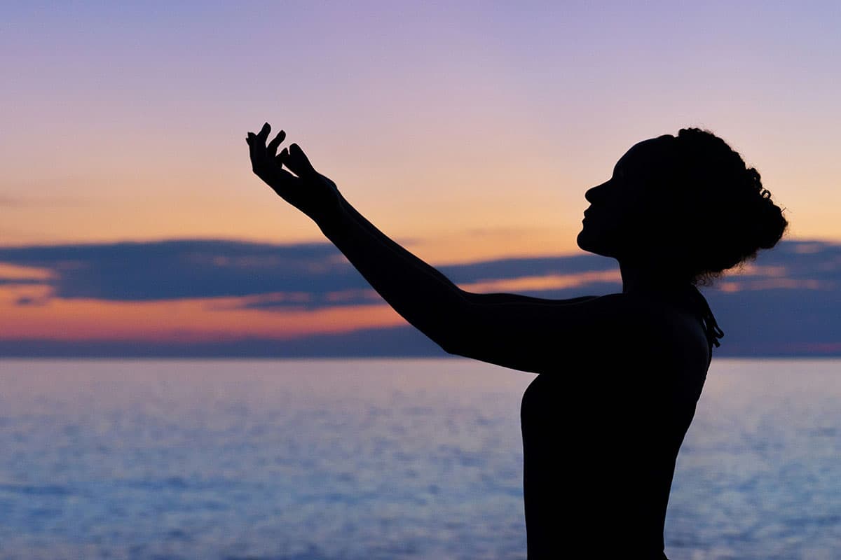 Silhouette of a woman with the sea in background